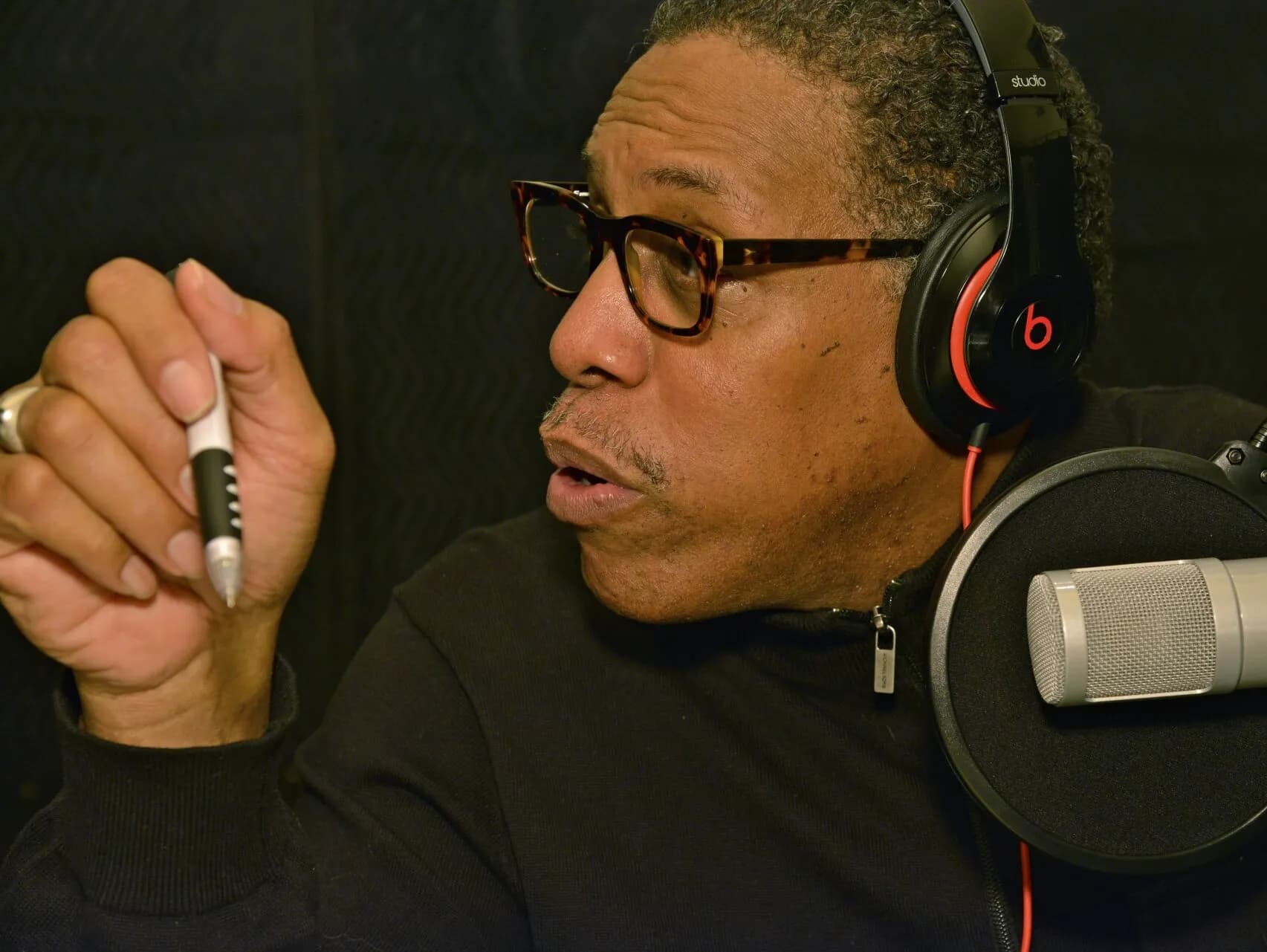 Howard Robertson speaking into a studio microphone